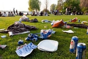 A street sweeper brush moves over a beer can on a Zurich street