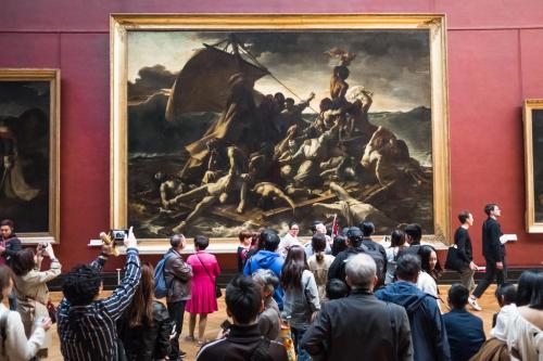 Tourists crowd and take picture in front of French artist Jean-Louis Andre Theodore Gericault's painting 'The Raft of the Medusa